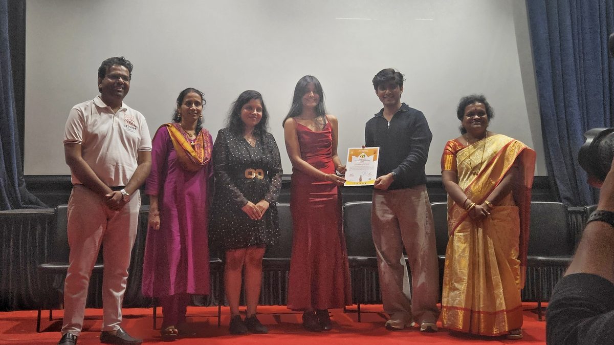 Student receiving a Certificate of Merit on stage from faculty and guests at the Mumbai University Youth Festival Finals